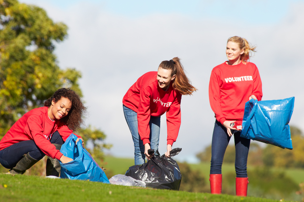 Group Of Female Volunteers Collecting Litter